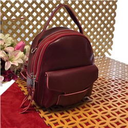 Миниатюрный сумка-рюкзачок Toffy из качественной натуральной кожи цвета спелой вишни.